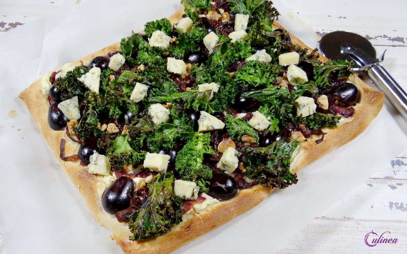 Pizza met rode ui, boerenkool, druiven en blauwe kaas
